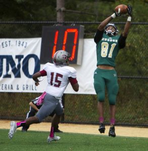 Husson's Kadeem Edge  leaps up to catch the ball in the end zone for a touchdown