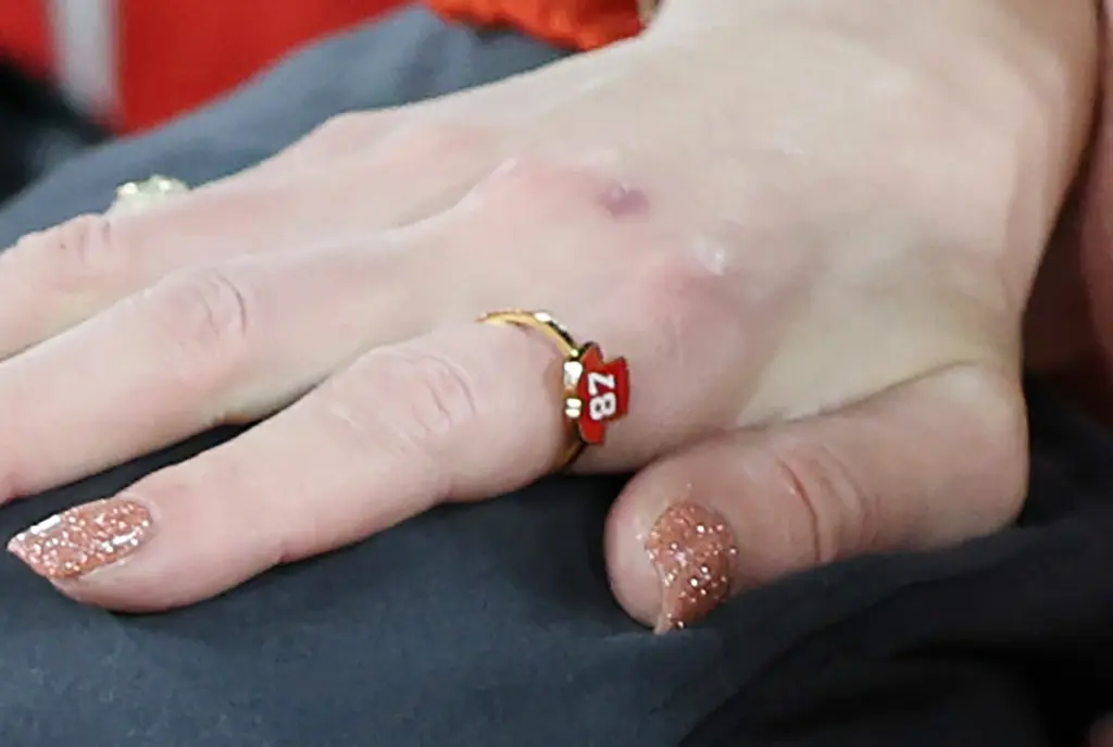Travis Kelce might not have put a ring on it yet, but his mom did. At Sunday’s Chiefs vs. Ravens playoff game, Taylor Swift cheered on boyfriend Travis Kelce wearing a bevy of sweetly symbolic baubles — including an EB & Co. ring ($14) featuring a miniature model of the tight end’s jersey. And the Kansas City business’ owner, Emily Bordner, says it all started with a shipment to the NFL pro’s mother, Donna Kelce. “We gifted Donna some [styles]. We know that she loved our earrings,” Bordner told KMBC. “We wanted to gift her even more Kelce-themed products. So, we sent those to her and then we were hoping that she would give them to Taylor. And she did.” Ever since Swift hit the suite rocking her meaningful ring, Bordner’s sales have soared.